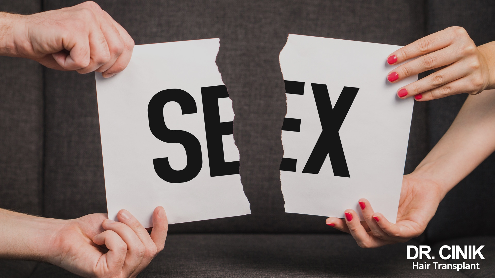 Sheet of paper bearing the word sex, torn in two between a man's hands and a woman's hands, against a dark sofa