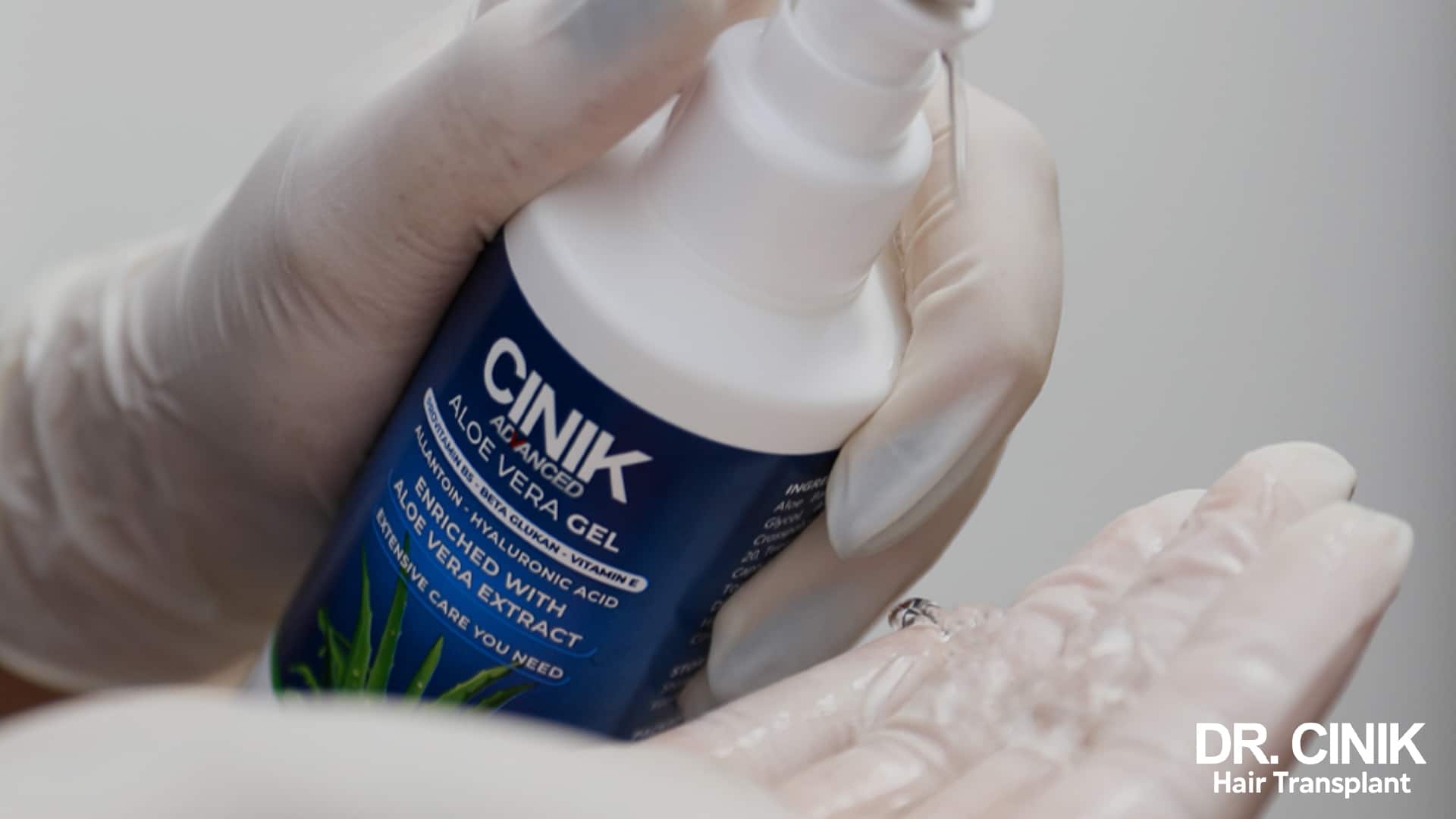 Dr Cinik aloe vera gel measured out into a gloved hand before application to the scalp