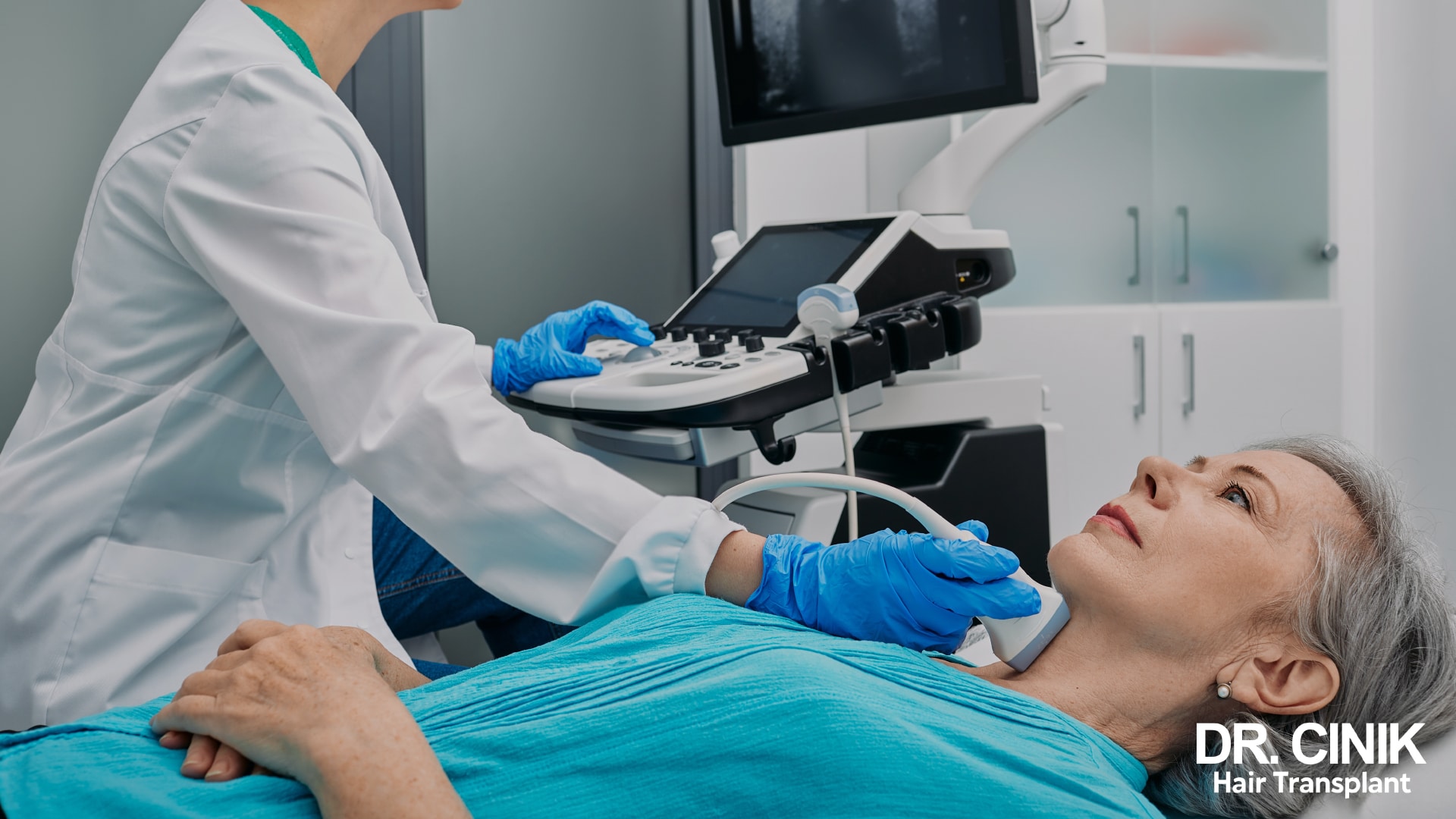 Gloved clinician running an ultrasound probe over the neck of a patient lying down, to examine the thyroid