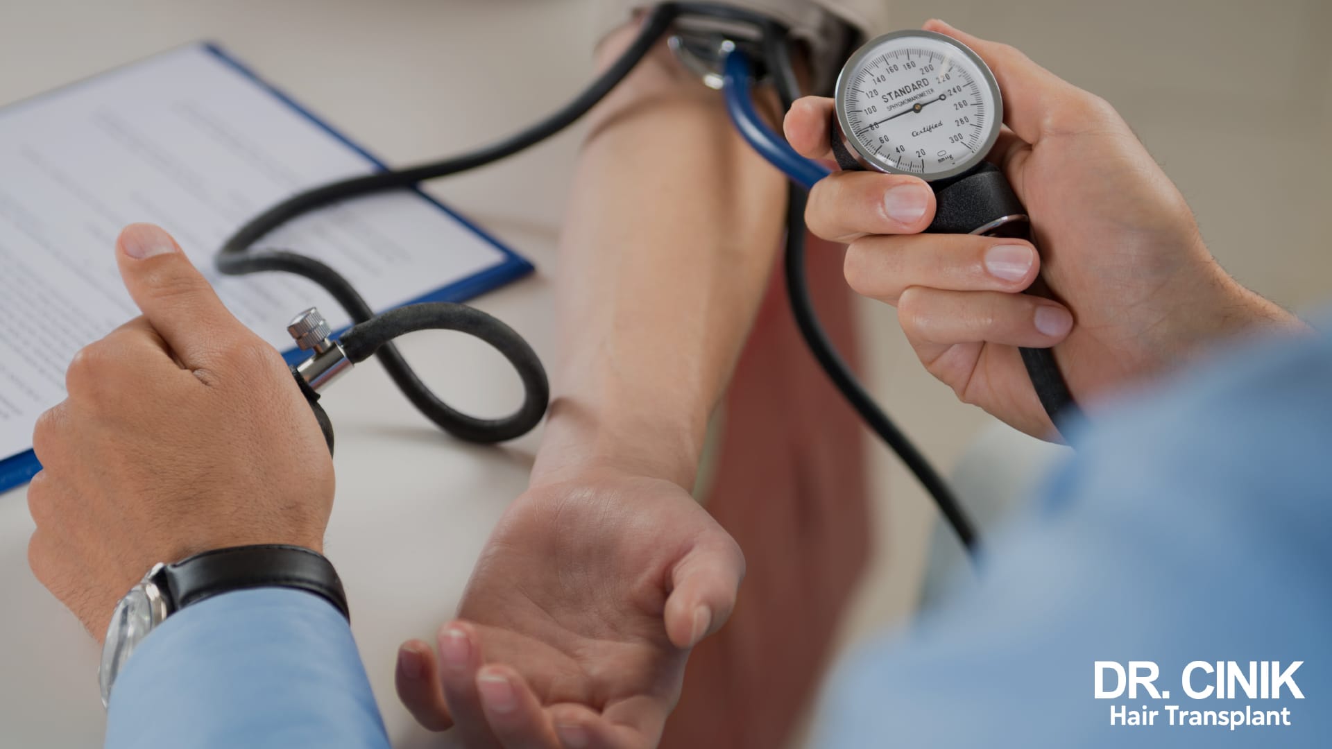 Medical consultation: a patient's blood pressure being measured, file open on the desk