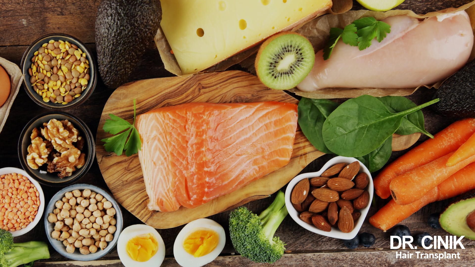 Spread of protein-rich and iron-rich foods, fresh salmon, chicken breast, hard-boiled eggs, lentils, chickpeas, almonds, walnuts, spinach and carrots