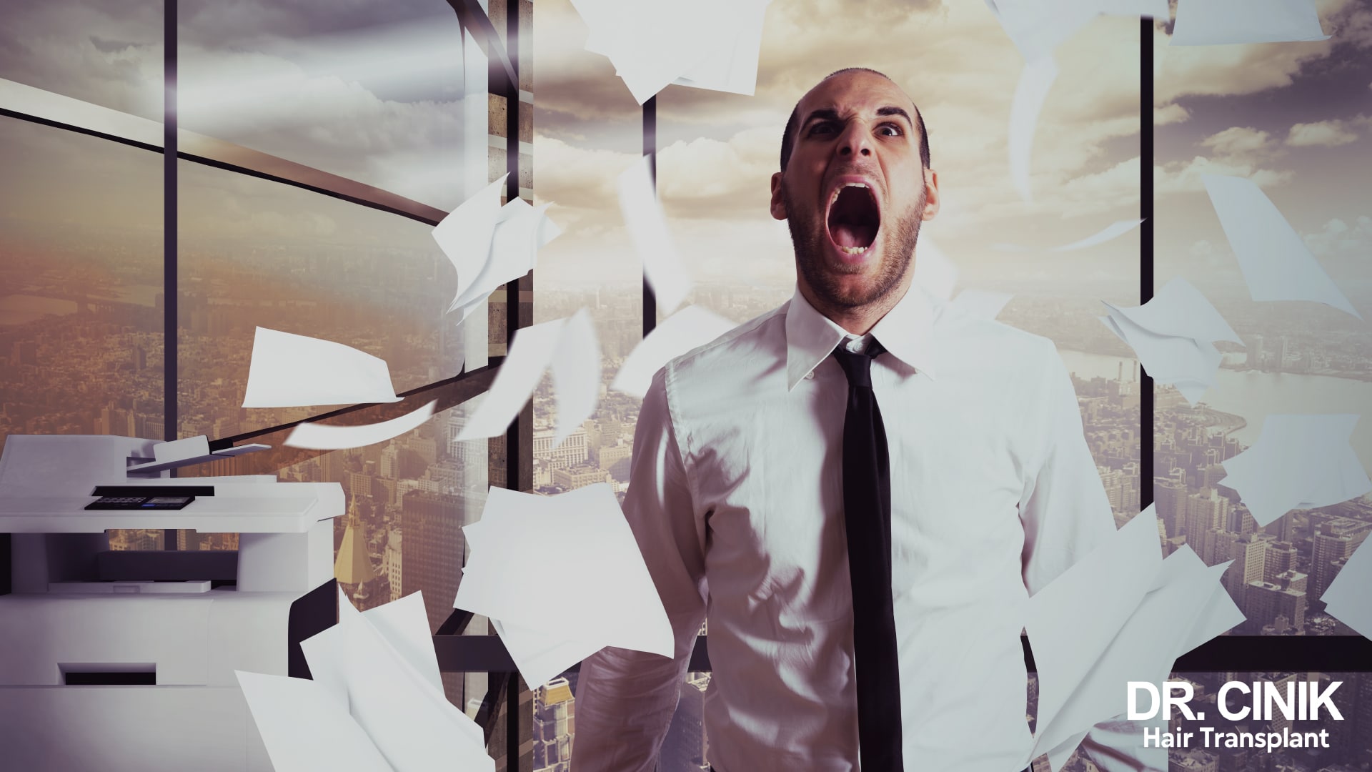 Man in shirt and tie shouting among sheets of paper flying around an office